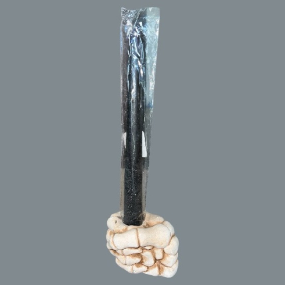 Skeleton hand candle holder with black candle